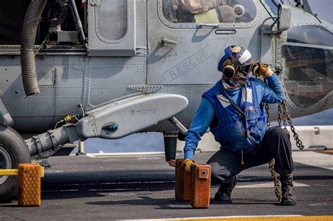 That definitely looks like a navy axe. FLIGHT OPSNavy Seaman John Quetel removes a chock... - Old ...