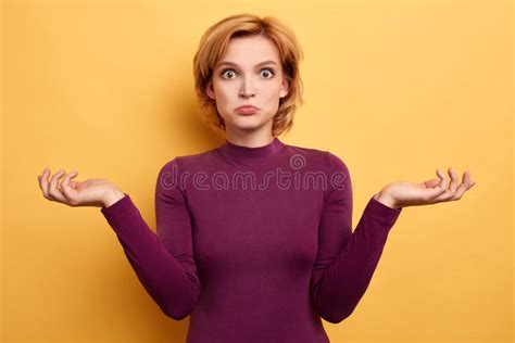 Puzzled Hesitant Blonde Woman Shrugs Shoulders Being Clueless And Uncertain Stock Photo