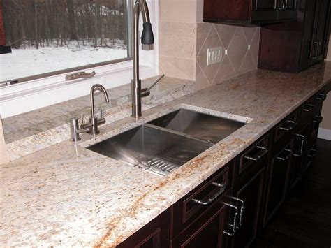 Cream kitchen cabinets with black granite countertops. Colonial Cream Granite