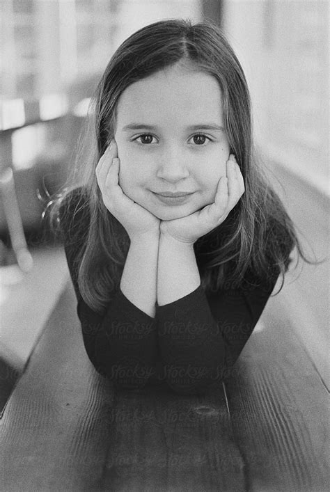 Black And White Portrait Of A Cute Young Girl Laying On A Bench Del Colaborador De Stocksy