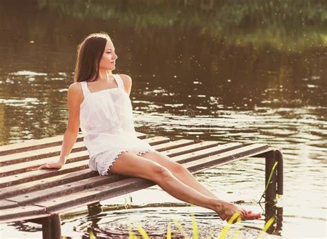 Young Girl Sitting On The River Bank Stock Image Image Of Tranquil