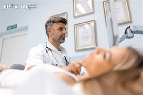 Close Up Shot Of Young Woman Getting Her Neck Examined By Doctor Using