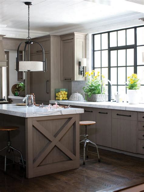This galley kitchen offers stylish kitchen counters with black countertops along with a small dining nook on the corner lighted by a classy ceiling lighting. Kitchen Lighting Ideas | HGTV