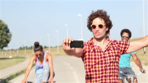 Three Young Adults Having Fun Cycling And Taking Selfies Stock Footage