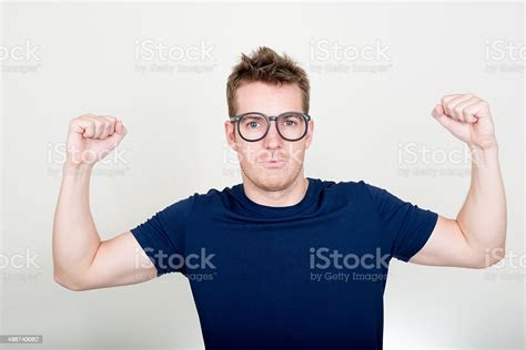Nerd With Funny Eyeglasses Flexing His Biceps Stock Photo Download