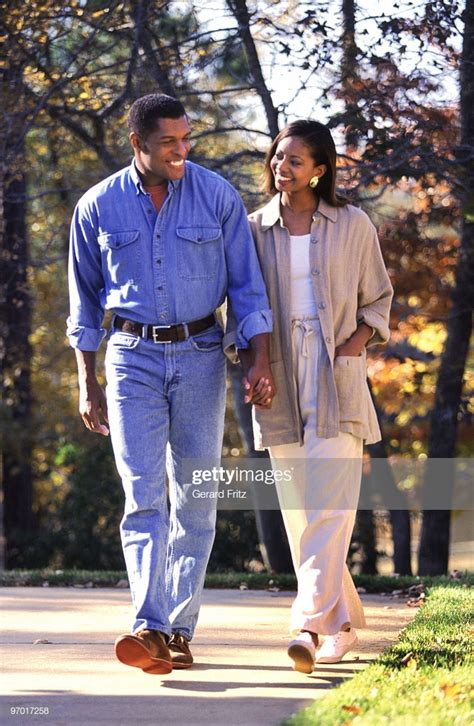 Black Couple Holding Hands Walking Outdoors High Res Stock
