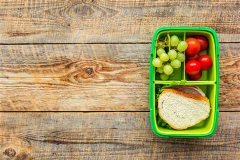 School Lunch Set With Sandwich And Vegetables In Lunchbox Background