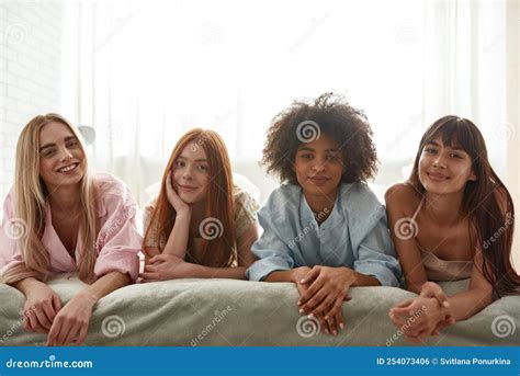 Group Of Smiling Multiethnic Girls Lying On Bed Stock Photo Image Of