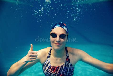 Female Swimmer Shows Thumbs Up Underwater In Pool Stock Photo Image