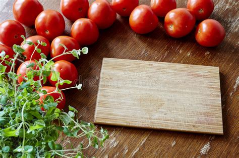 Cutting Board Surrounded By Tomatoes Stock Photo Image Of Board