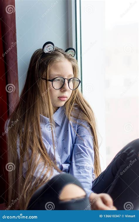 Portrait Of A Teen Girl With Glasses Sitting By The Window Stock Image