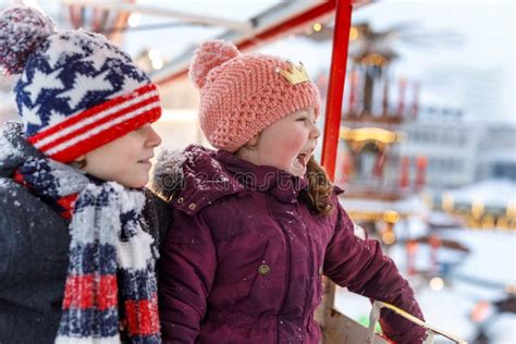 Two Little Kids Boy And Girl Having Fun On Ferris Wheel On Traditional