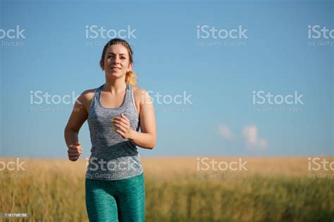 Woman Jogger Working Out In The Morning Sunny Day Stock Photo