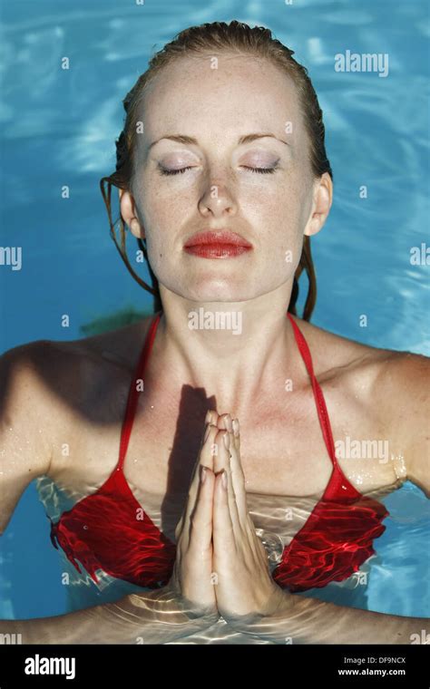Year Old Woman In Meditation Inside Swimming Pool Wearing Red Bikini Stock Photo Alamy