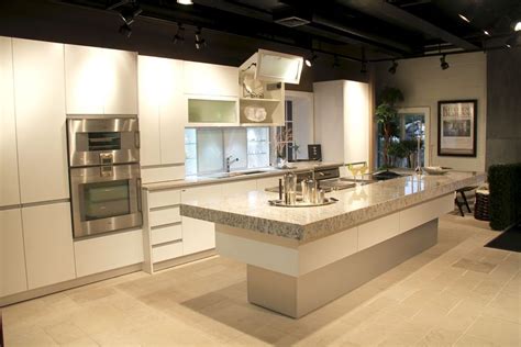 Transitional white kitchen with dark walnut wood island. Sag Harbor Kitchen Showroom at Kitchen Designs by Ken ...