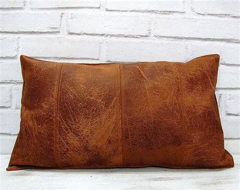 Place throw pillows on a bare sofa to spruce up the furniture's design. Brown faux leather fabric lumbar pillow cover with ...