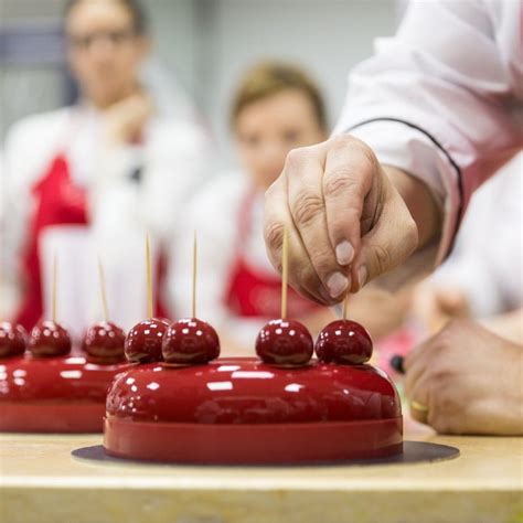 Using chilled ganache, decoratively pipe stars on top of cake. Black Forrest Entremet presented by Chef Antonio Bachour ...