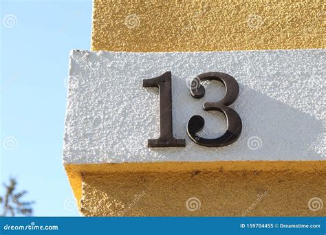 Number Thirteen Written On Yellow And White Wall Stock Image Image Of