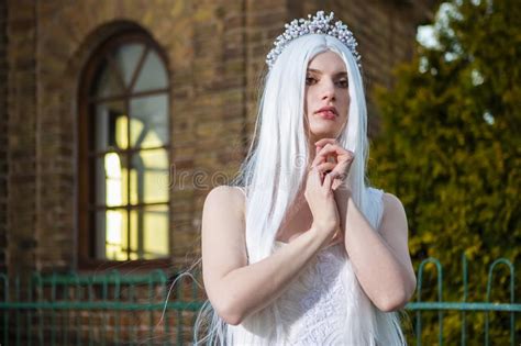 Sensual Relaxed Caucasian Bride With Tiara And Long White Hair Posing