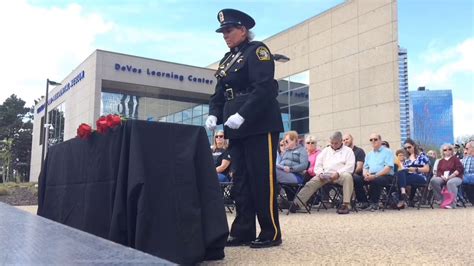 Officers Place Roses At The Police Memorial Service In Grand Rapids