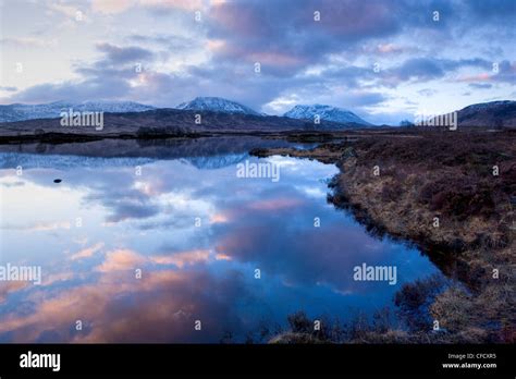 Dawn View Of Loch Ba Reflecting The Sky And Distant Snow Capped