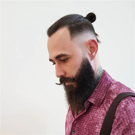 There are lots of easy hairstyles that you can do at home. Picture Of a hipster man bun hairstyle