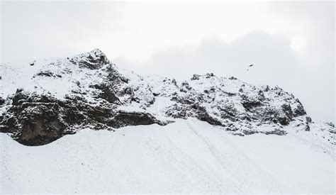 Snow Covered Rocks During Daytime Photo Free Mountain Image On Unsplash