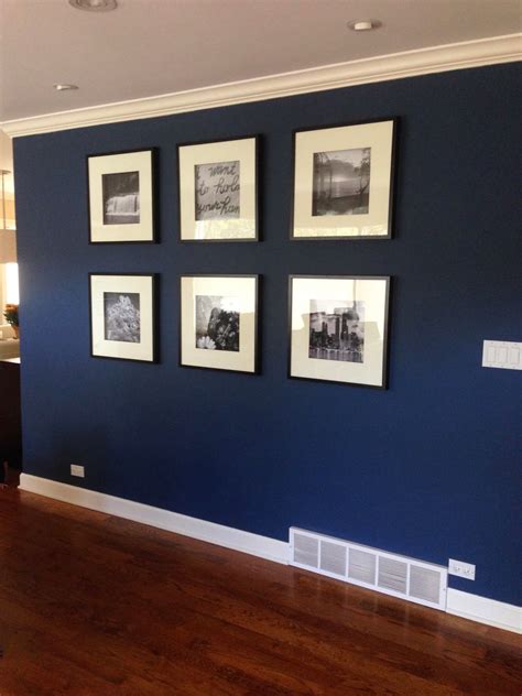 Elegant White Pictures Frame Hanging On Blue Accent Wall