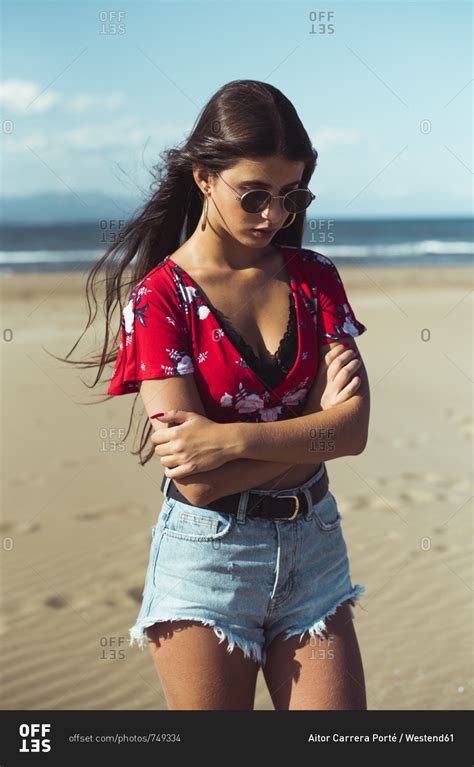 Portrait Of Fashionable Teenage Girl Standing On The Beach