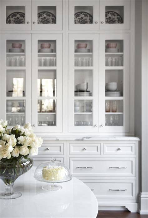 I recently shared my kitchen makeover, and i had several requests to share how i replaced the raised panels on my kitchen cabinets with glass. Beautiful white kitchen inset cabinets glass doors marke ...