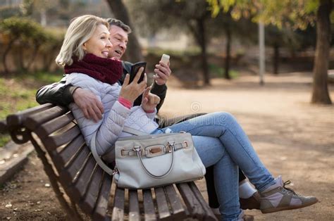 Smiling Mature Couple Exchanging Phone Numbers Stock Photo Image Of
