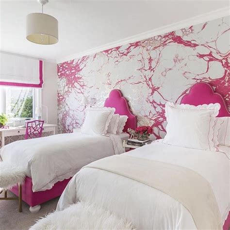 “in the girls bedroom sophisticated wallpaper takes the edge off the hot pink color scheme