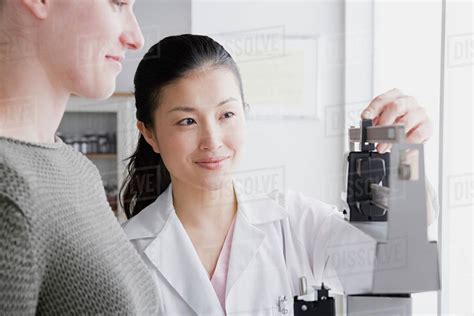Close Up Of Female Doctor Measuring Woman S Weight Stock Photo Dissolve