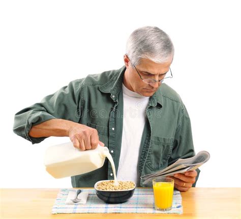 Middle Aged Man Pouring Milk Into His Cereal Bowl Stock Photo Image