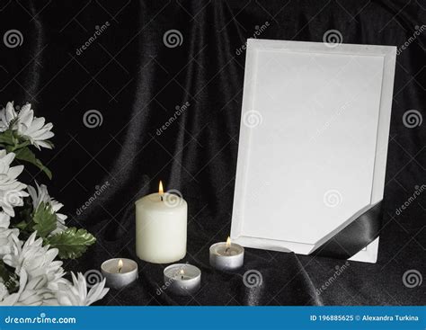 The Concept Of Wake Candles And White Flowers On A Black Background