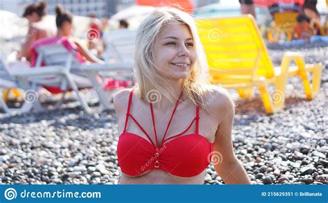 Beautiful Blonde In A Red Swimsuit On A Crowded Beach Sunny Beach In Batumi Stock Image Image