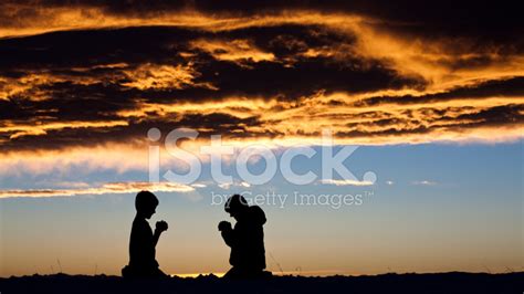 Silhouette Of Two Children Praying Stock Photos