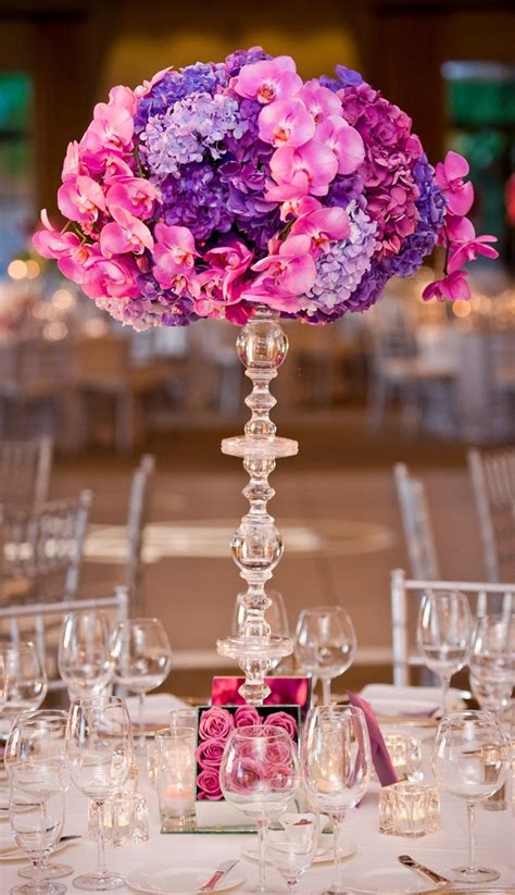 Go traditional with flowers as your wedding reception centerpieces. Get Creative With Vases! - B. Lovely Events