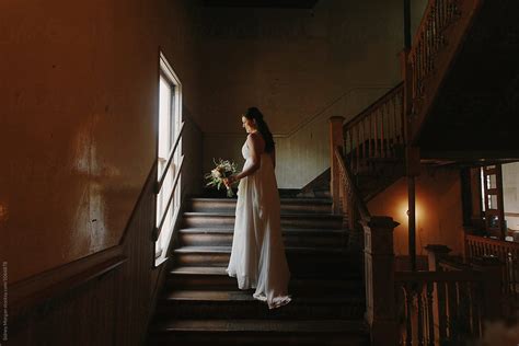 Bride Standing By Window On Stairs By Stocksy Contributor Sidney