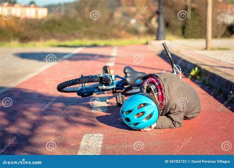 Boy Touching His Head After Falling Off To Bicycle Stock Photo Image