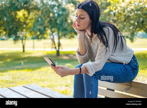 Sad Girl Waiting For A Mobile Phone Call Or Message From Her Boyfriend