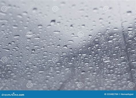 Raindrops Dripping Across A Window In A Cold Winter Day Close Up