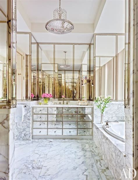 An Elegant Bathroom With Marble Floors And Large Mirrors On The Wall