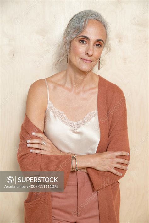 Calmly A Middle Aged Woman With Gray Hair Looks Into Camera Superstock