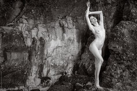 Nude Woman Posing Outdoors Against A Rock Wall By Stocksy Contributor