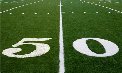 Football grass background in light and shadow. Football Turf - Total Football