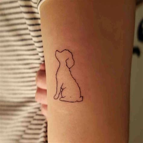 A Small Dog Tattoo On The Right Forearm And Wrist With A Silhouette Of