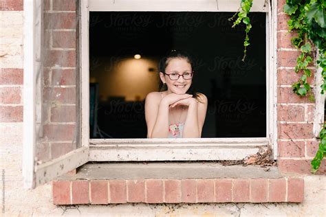 View Portrait Of A Teen Girl In A Window By Stocksy Contributor