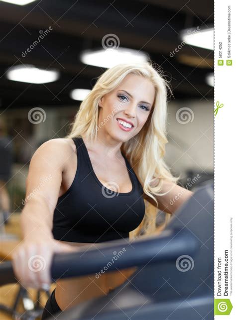While at the gym may mean in the buildind as well as behind,in fron of, or just near to the building. Blonde Woman In Gym On Treadmill Stock Photo - Image: 58314252