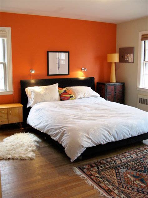 The fiery orange wall creates a dramatic effect as. Lucy & Thomas Say Goodbye to their Artful Family Home | Orange bedroom walls, Bedroom orange ...